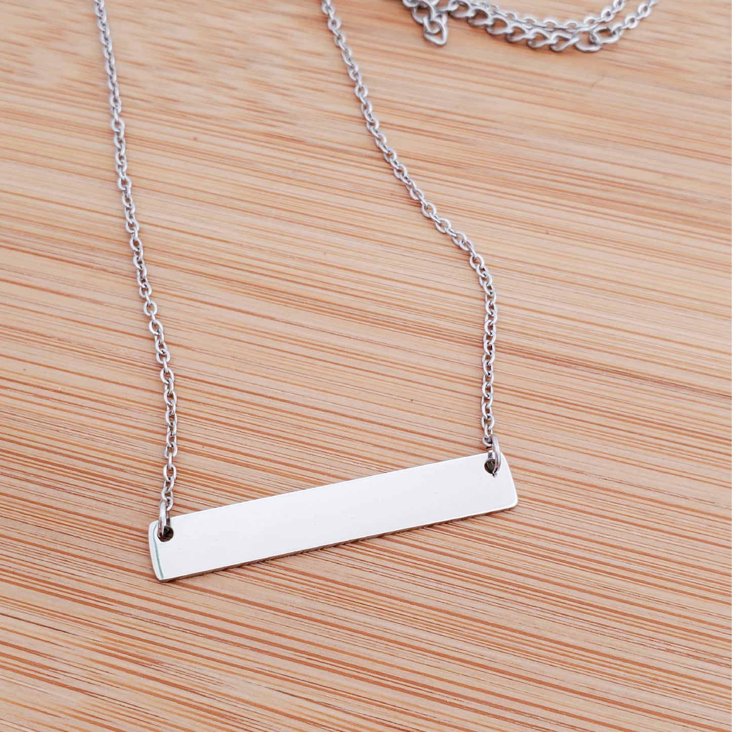 A CUSTOM ENGRAVED BAR NECKLACE