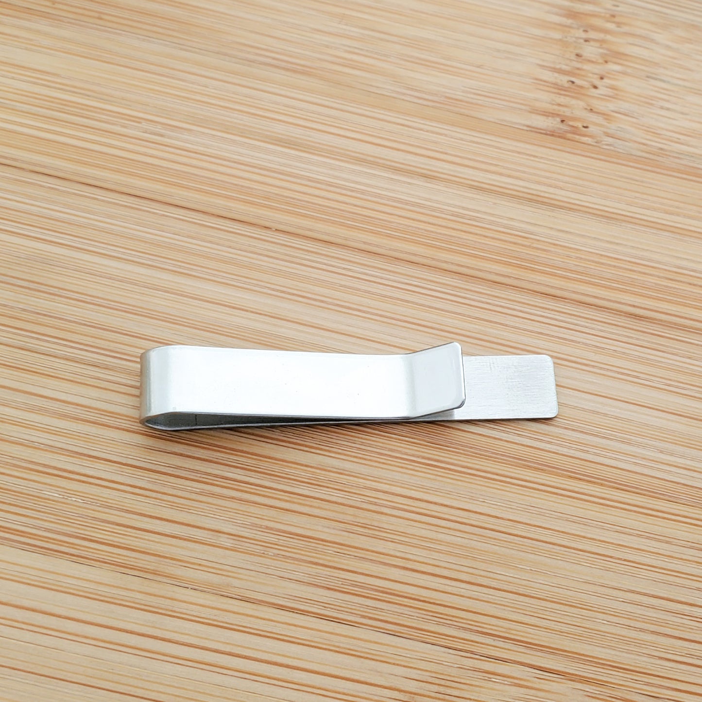 A CUSTOM ENGRAVED TIE CLIP